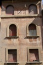 Exterior red wall of old building with windows Royalty Free Stock Photo