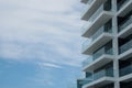 Exterior of residential building with balconies against blue sky, low angle view. Space for text Royalty Free Stock Photo