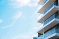Exterior of residential building with balconies against blue sky, low angle view. Space for text Royalty Free Stock Photo