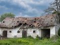 Exterior of the ruins of an old village abandoned house with a ruined tiled roof Royalty Free Stock Photo