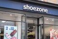 Exterior of Shoezone dicount value shoe footwear shop. Showing logo, sign, signage and branding of company branches