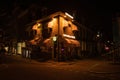 Exterior shot of cafe brightly illuminated at night by the street lighting in Amsterdam,Netherlands