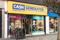 Exterior shot of Cash Generator Pawn Shop with electronics, jewelry and bikes on display