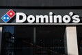 Exterior shot of Dominos Pizza Take Away Food Chain.  Sign and logo Royalty Free Stock Photo