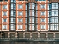 Exterior shot of new red brick residential house building with parking garage gates