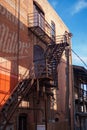 fire escape stairs next to a red brick building and sign