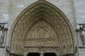 Exterior shot of a stone entrance of Notre Dame Cathedral of Paris