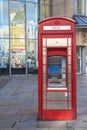 Exterior shot of a telephone kiosk on the pavement with ATM cash point built in. Modern retro design