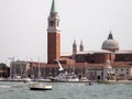 Exterior side view of San Giorgio Cathedral in Venice, Italy with yachts and sky in the background