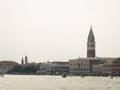 Exterior side view of San Giorgio Cathedral in Venice, Italy with yachts and sky in the background