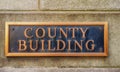 Exterior sign that reads `County Building` in brass lettering. Close up Royalty Free Stock Photo