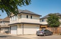 Exterior of Small New Custom Home in North America. Two story house with small entrance porch and garage with driveway Royalty Free Stock Photo