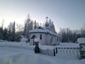 Exterior of St Nicholas Russian Orthodox Church in Eklutna, Alaska on a Clear Winter Day, White Wooden Church