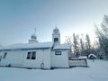 Side View of St Nicholas Russian Orthodox Church in Eklutna, Alaska on a Clear Winter Day, White Wooden Church Royalty Free Stock Photo