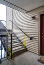 Exterior stairway of residential building with yellow caution construction tape