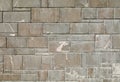 Exterior stone wall coating made by gray granite rock tiles of differen sizes.