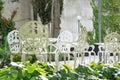 Exterior terrace and garden with white metal classical decoration. Chairs, flowers and empty copy space