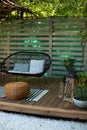 Exterior Terrace with green plants, sofa and lanterns. Cozy space in patio or balcony. Interior Wooden veranda with garden armchai