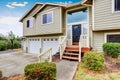 Exterior of Two story clapboard siding house with three garage spaces