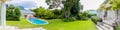 Exterior of Upmarket wealthy suburban mansion house with landscaped garden and swimming pool Royalty Free Stock Photo