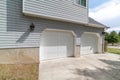 Exterior view of attached garage of house with two white panelled doors