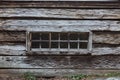 Exterior view of a bank of windows in an old mountain log cabin Royalty Free Stock Photo