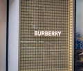 Exterior view of a Burberry store and company logo in the huge luxurious mall