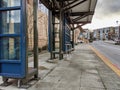 Exterior view of a bus bay at the downtown Kirkland Transit Center near the King County Library and parking garage