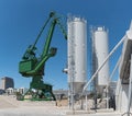 Exterior view of a cement factory with crane and concrete mixing silo Royalty Free Stock Photo