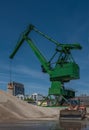 Exterior view of a cement factory with green crane Royalty Free Stock Photo