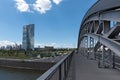 Exterior view of a cemthe honsell bridge with new building of the european central bank ezb in Frankent factory with green crane