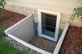 Exterior view of an egress window in a basement bedroom. These windows are required as part of the USA fire code for basement