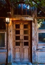 Exterior view and front door of beautiful old traditional house. The entrance is covered with ivy. wooden house Royalty Free Stock Photo