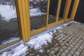 Exterior view of glass wall of modern house and icy paving slabs. Royalty Free Stock Photo