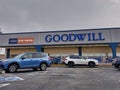 Exterior view of a Goodwill Donation and Thrift Shop, cars lining up for the donation line