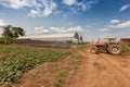 Exterior view of greenhouse with farming tractor.