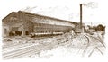 Exterior view of a historical factory building with rails, wagons and a smoking chimney in front of it