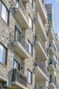 Exterior view of luxury apartment with small balconies and stone brick wall Royalty Free Stock Photo