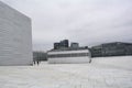 Oslo, Norway, September 2022: Exterior view of the modern Oslo Opera House building, with people walking on the roof. Royalty Free Stock Photo