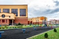 Exterior view of modern public school building with playground. Royalty Free Stock Photo