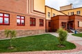 Exterior view of modern public school building with playground. Royalty Free Stock Photo