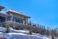 Exterior view of a mountain home with blue sky background on a sunny winter day