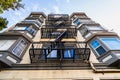 Exterior view of multifamily residential building; Old metal fire escape stairs hanging on side of the building; Berkeley, San Royalty Free Stock Photo