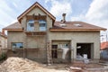 Exterior view of new house under construction and painting. External plaster of the walls of a two-story house. Royalty Free Stock Photo