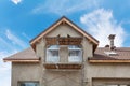 Exterior view of new house under construction and painting. External plaster of the walls of a two-story house. Royalty Free Stock Photo