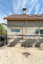 Exterior view of new house under construction and painting. Scaffolding for exterior plastering at home side view. Royalty Free Stock Photo