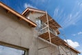 Exterior view of new house under construction and painting. Scaffolding for exterior plastering at home. Royalty Free Stock Photo