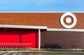 Exterior view of a newly remodeled Target store, with white bullseye logo, red and brown colors and shopping carts