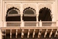 Exterior view of an ornately carved window and balcony on an old temple in Vrindavan