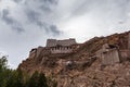 Exterior view of ruin of famous Gyantse Dzong, Gyantse Fortress on a cloudy summer day, located on top of mountain, with colorful